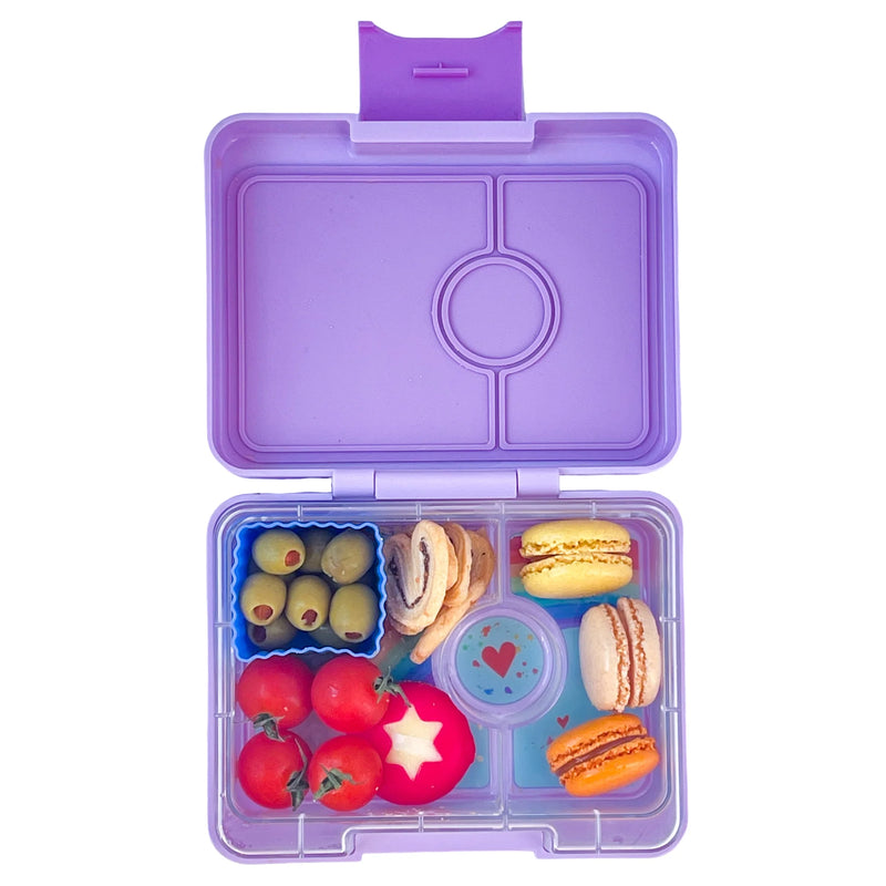 Yumbox MiniSnack snack box filled with fresh fruit and a bit of chocolate.